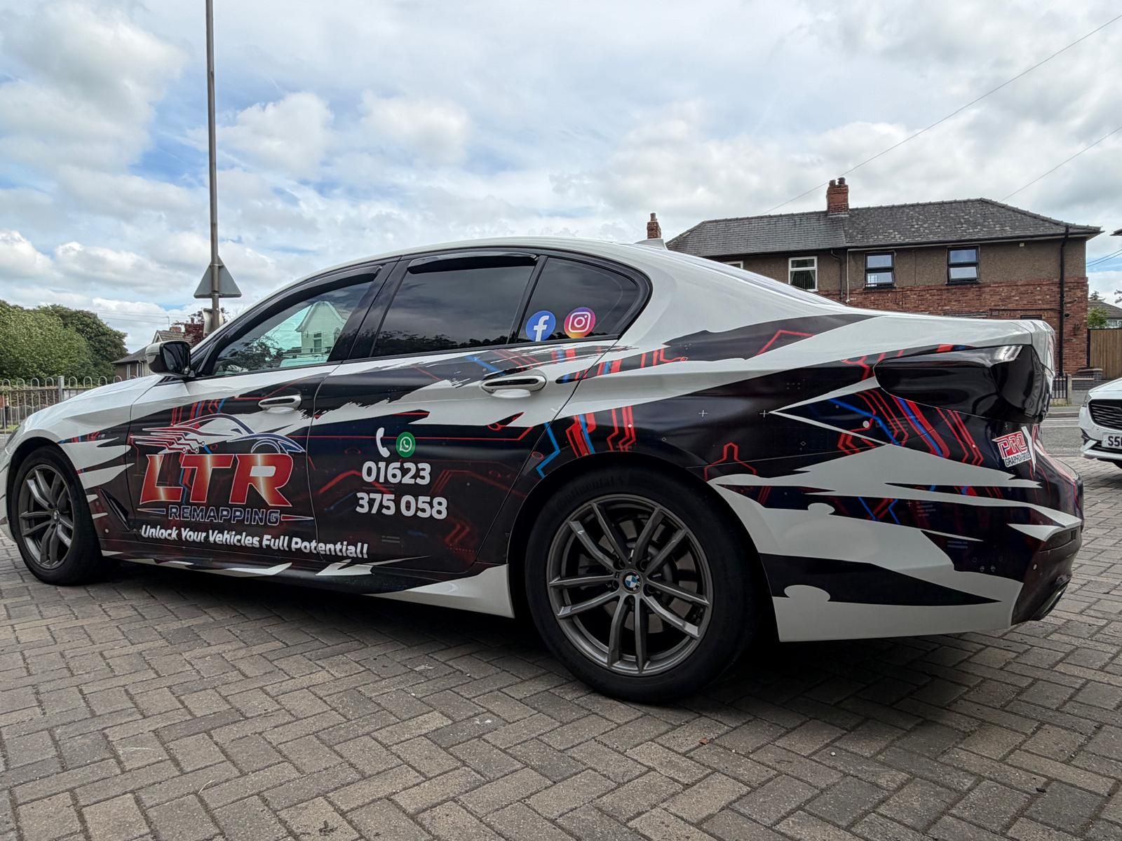 White BMW wrapped in LTR Remapping graphics with logo decals