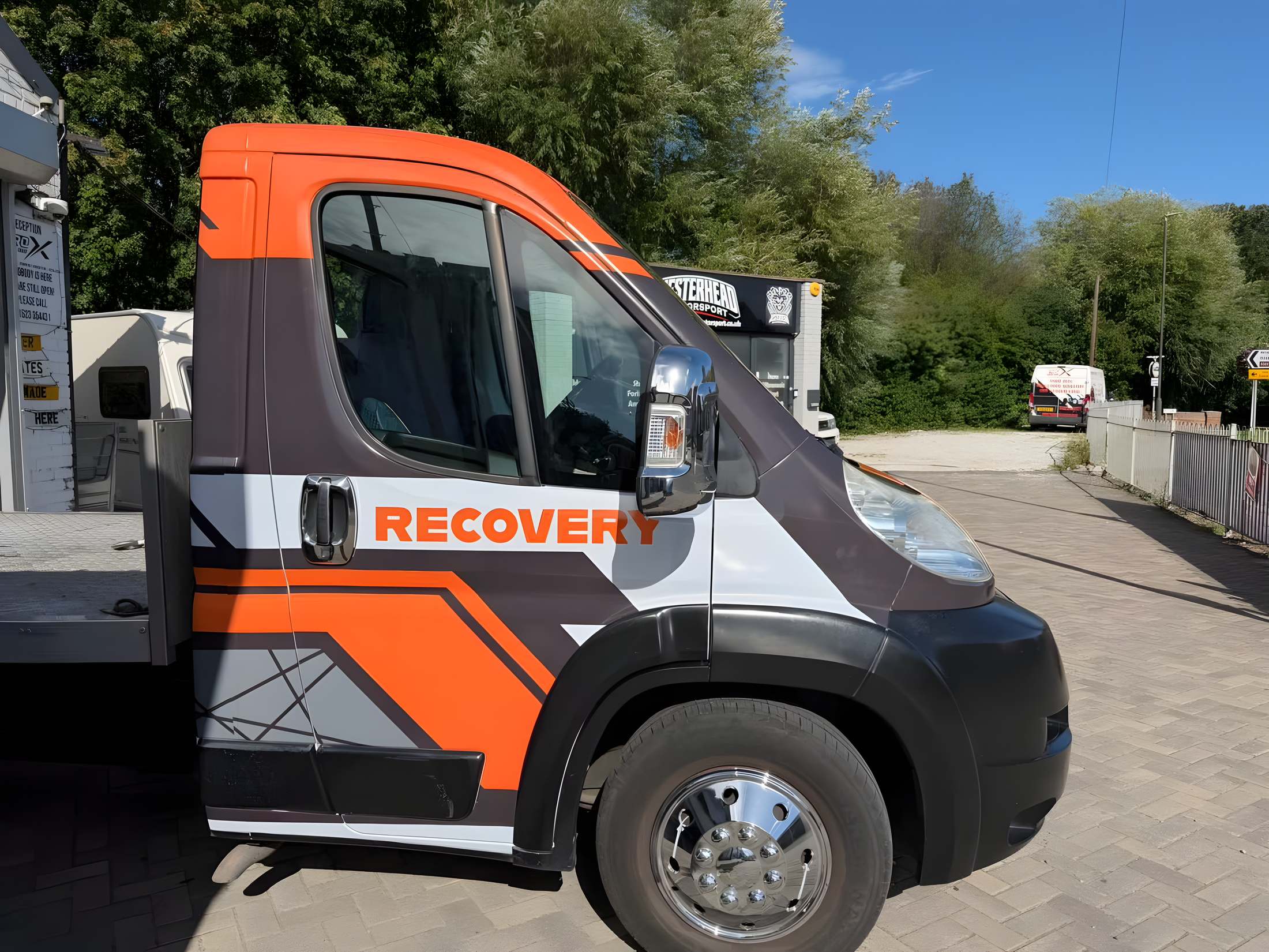 Orange and black RECOVERY livery on a Citroen recovery truck