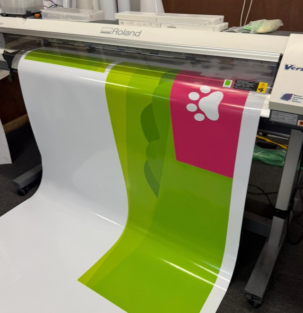 Roland printer producing large format vinyl with a paw print design