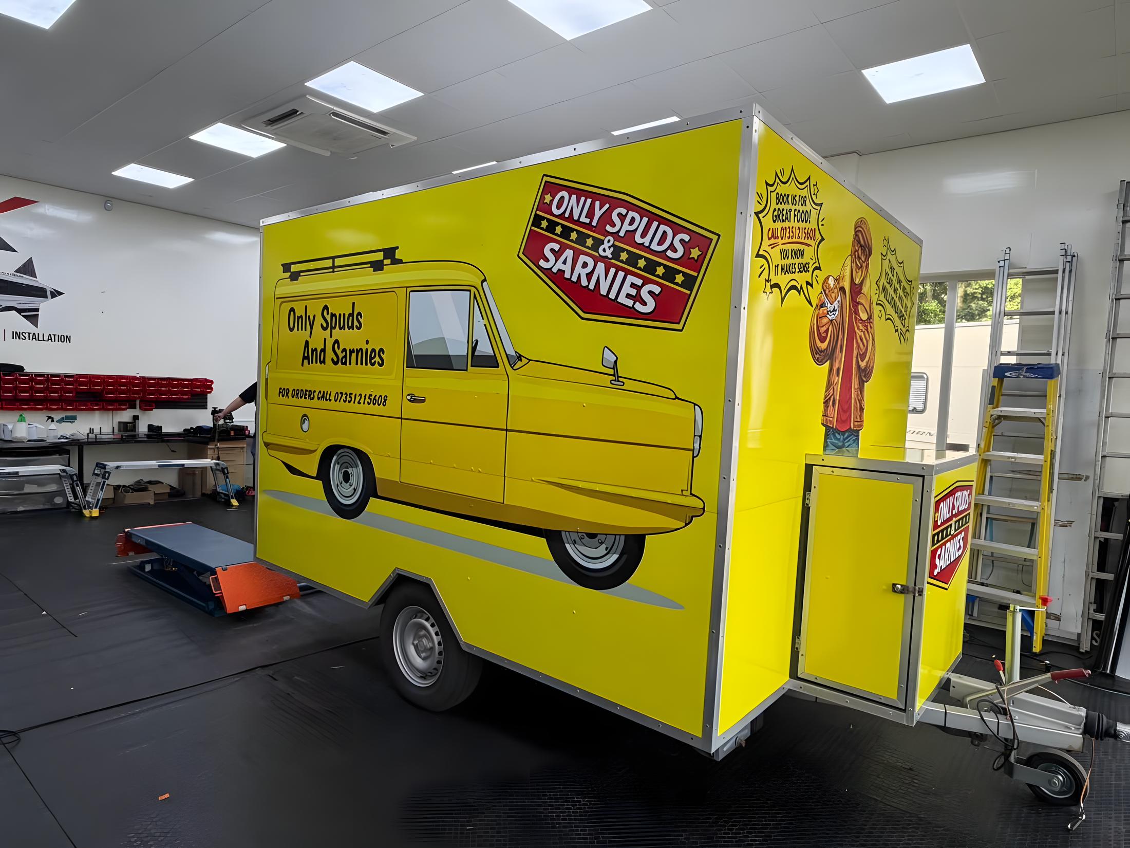 Wrapped Only Spuds & Sarnies trailer inside the Pro Graphix unit