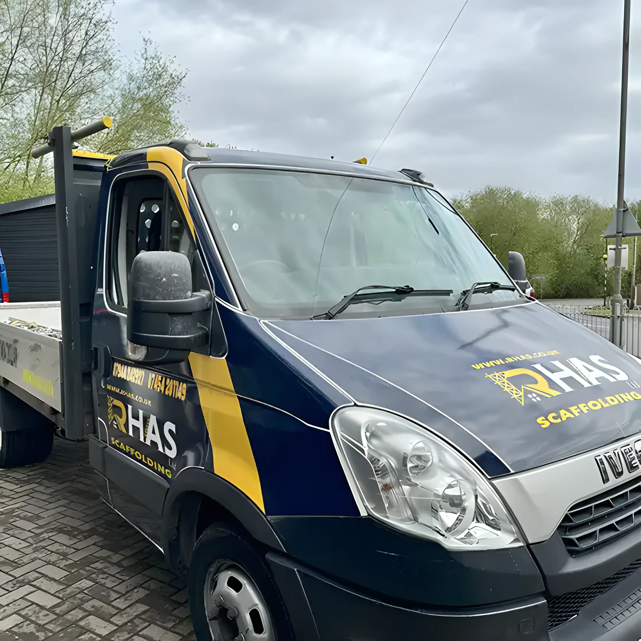 Van Wraps – RHAS Scaffolding Iveco tipper wrapped in navy with yellow stripes